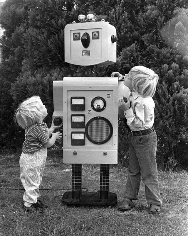 London, England, 29th August 1973, Two little boys study a five foot robot built by their father Peter Stanley in the garden of their London home